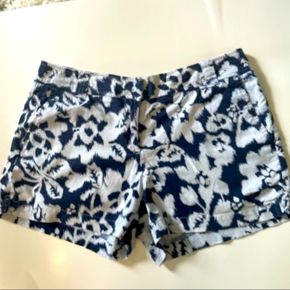 Navy blue and white batik floral print shorts.